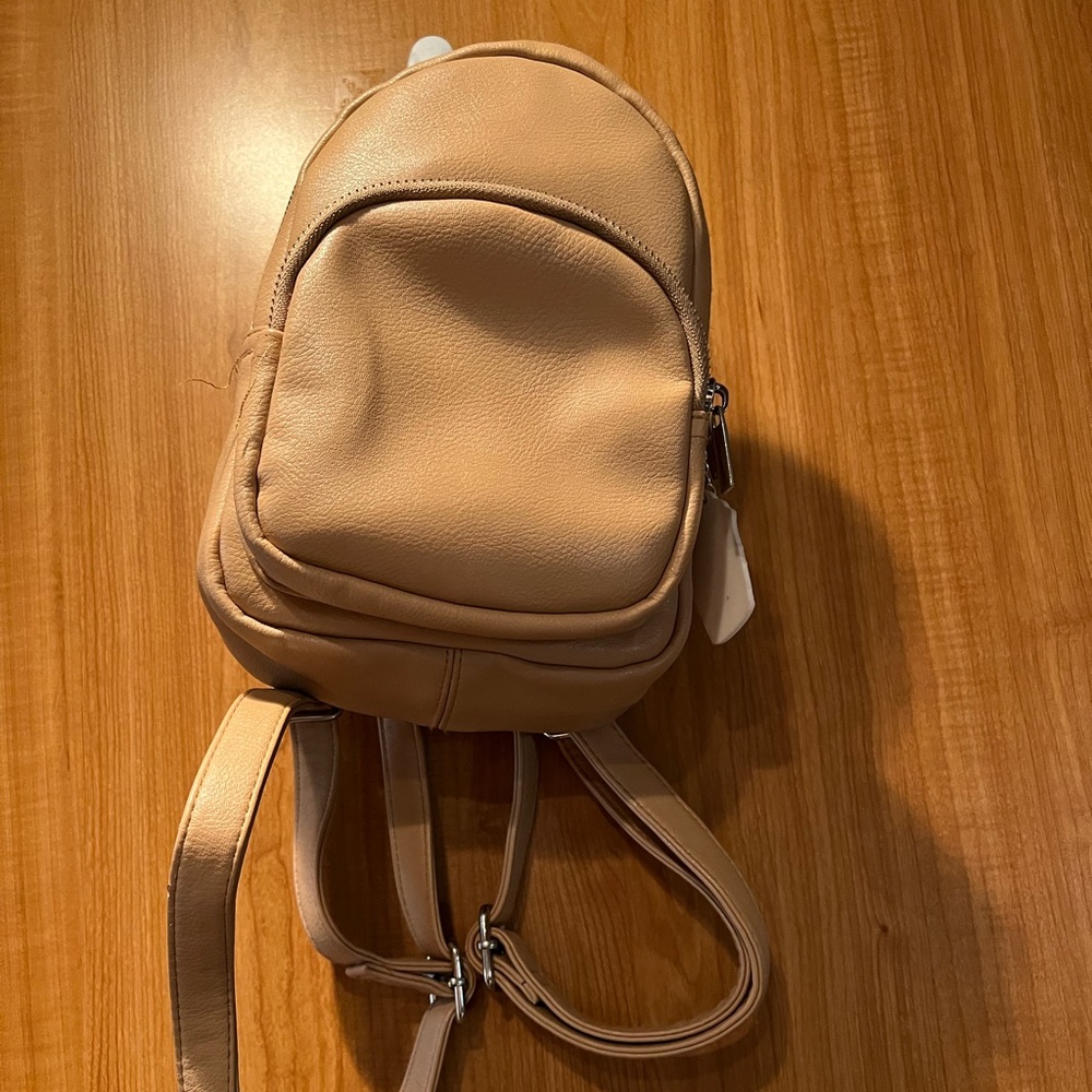 Small tan backpack with BFF keychain.